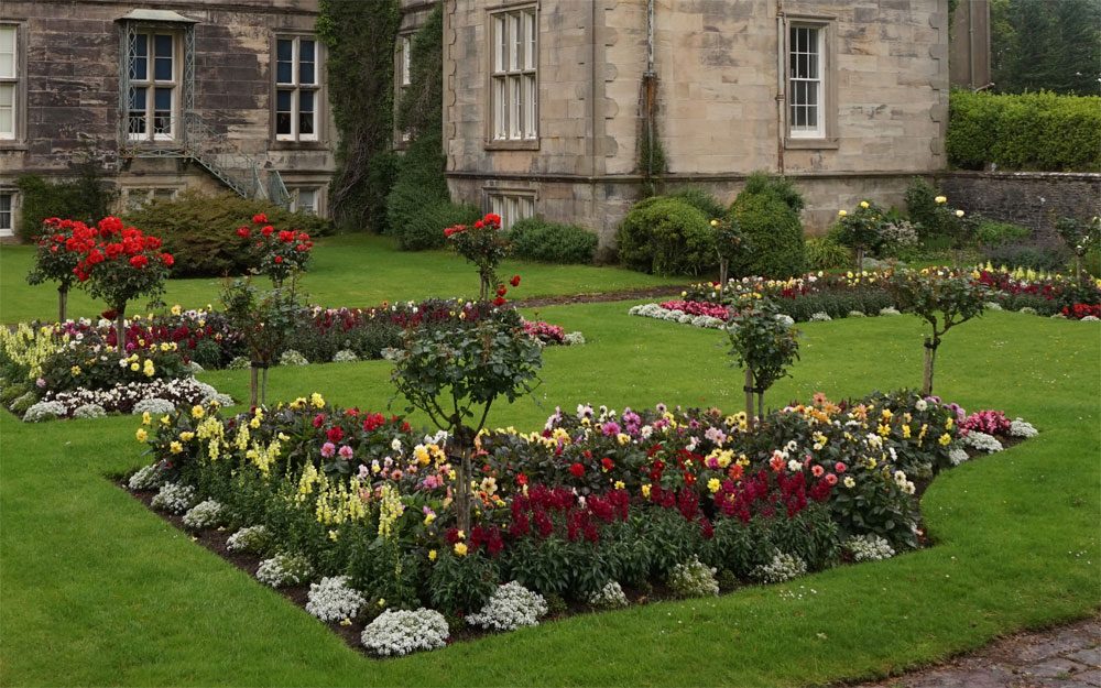 Neatly edged lawn with colorful flower beds